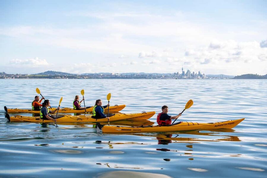 Auckland: Sunset & Night Sea Kayak Tour to Rangitoto Island - The sunset payoff over the Waitakere Ranges