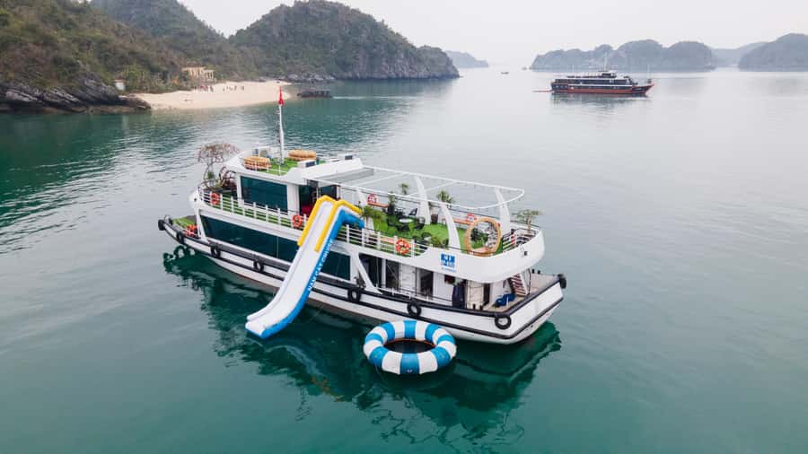 Cat Ba : Lan Ha Bay Bioluminescent Plankton Kayak Boat Tour - Cruising past the floating fisherman village