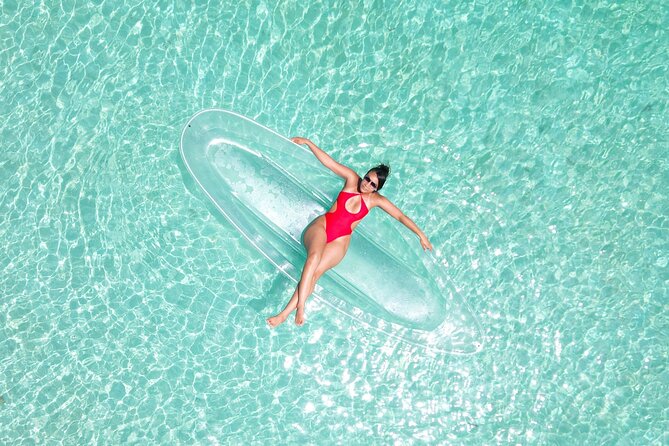 Crystal Clear Kayak Drone Photography Antigua - Getting into the clear kayak at Hermitage Bay