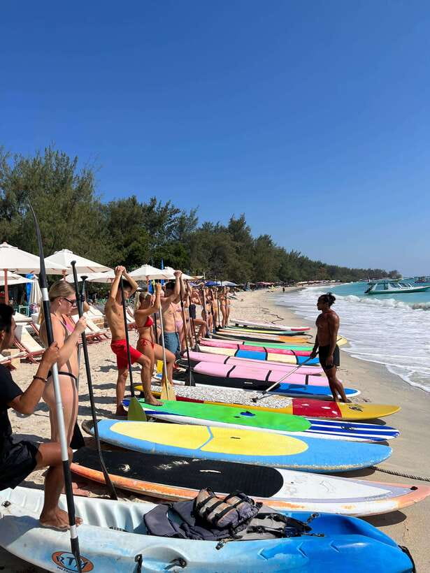 gili sunrise Stand-up paddle boarding or kayaking (droneshot - Crossing toward Gili Meno and the underwater statues