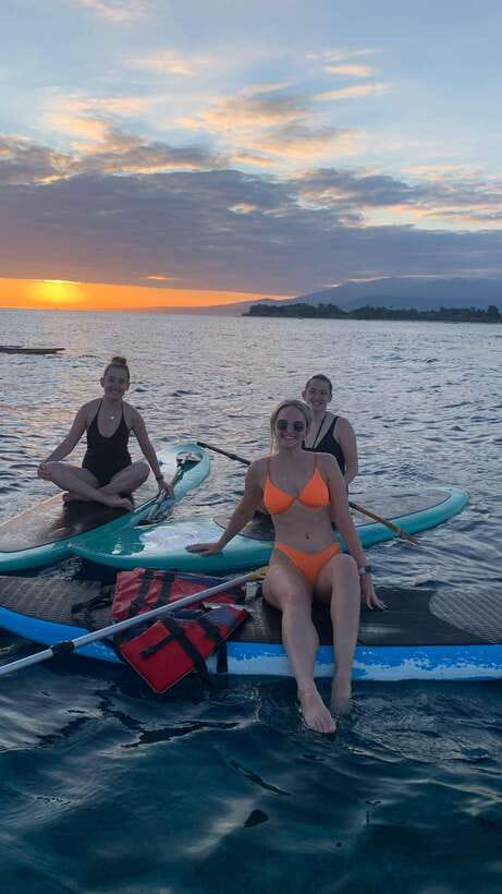 gili sunrise Stand-up paddle boarding or kayaking (droneshot - The beach-front restaurant and young coconut