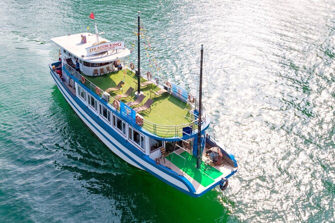 Halong Bay Day Tour With Titop Island, Cave, Kayak & Lunch - Sunset, fruit, and cake on the return cruise