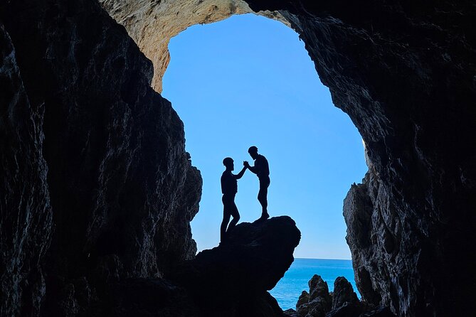 Kayak through Morro de Toix and Cueva dels Coloms - Entering Cueva dels Coloms with a helmet and front lamp