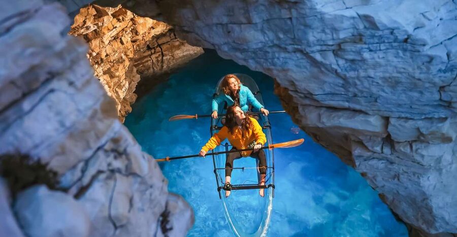 Pula: Night-Time Sea Kayaking Tour in Transparent Kayak - Entering the small cave by glowing kayak