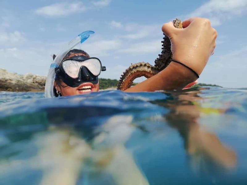 Pula: Sea Adventure – Boat, Kayak, Snorkeling & Cliff Jumps - Paddling past cliffs and into rocky passages