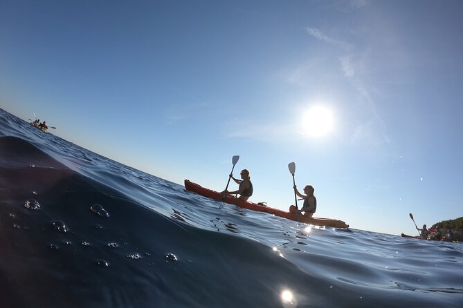 Pula: Sunset Adventure – Boat, Kayak, Snorkeling & Sunset - Paddling below Pula’s highest cliffs