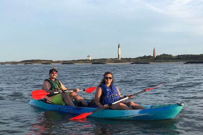 Sunset Dolphin Kayak Tours - Cape Henry Lighthouses from the water